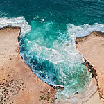 Ideal for island weddings, this aerial view captures the beauty of a beach and ocean.