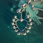 An aerial view of a heart-shaped resort in the ocean, perfect for a romantic Jamaican wedding.