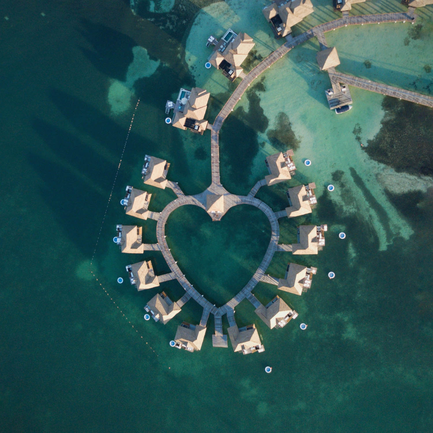 An aerial view of a heart-shaped resort in the ocean, perfect for a romantic Jamaican wedding.