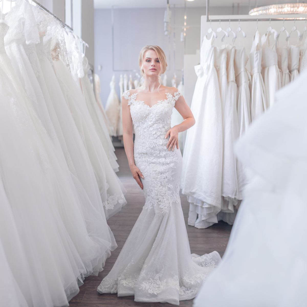 A woman in one of the best wedding dresses standing in a bridal shop.