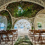 An outdoor wedding ceremony set up on the beach at Sandos Caracol weddings.