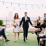 A bride and groom walking down the aisle at an outdoor wedding coordinated by a Chicago wedding planner.