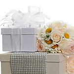 A bouquet of flowers on a white gift box for wedding registry etiquette.