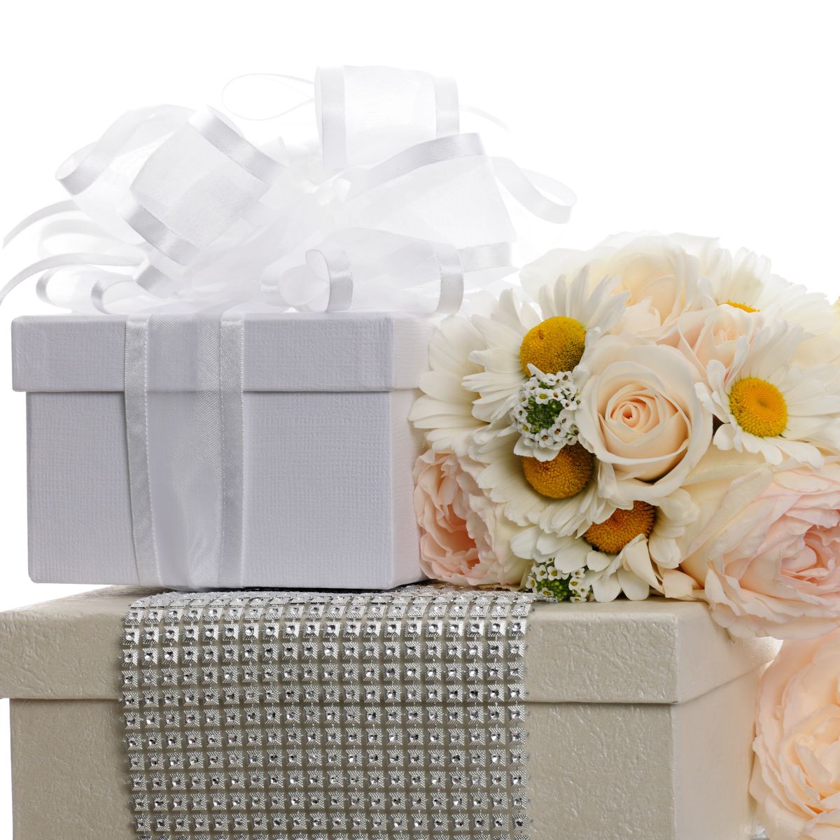 A bouquet of flowers on a white gift box for wedding registry etiquette.