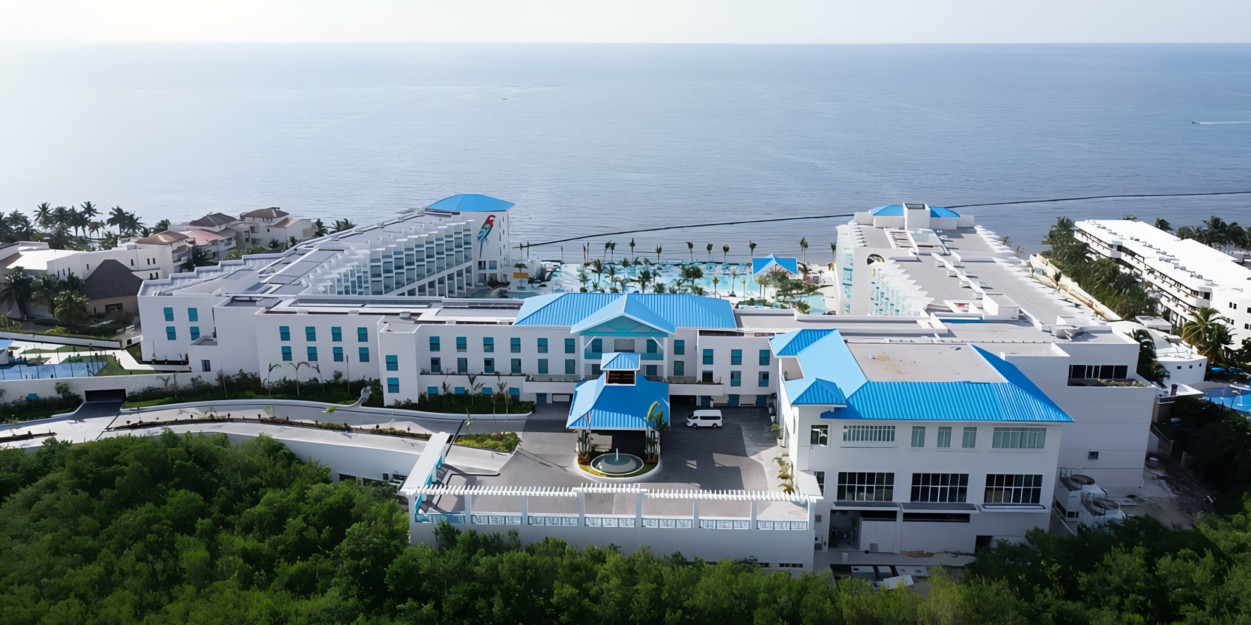 An aerial view of Margaritaville Island Reserve Riviera Maya near the ocean.