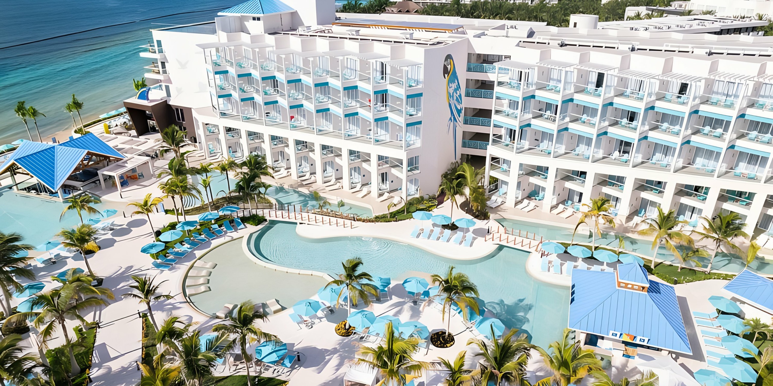 An aerial view of Margaritaville Island Reserve Riviera Maya with a pool and beach.