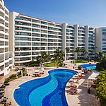 A swimming pool and lounge chairs at a resort in Puerto Vallarta.