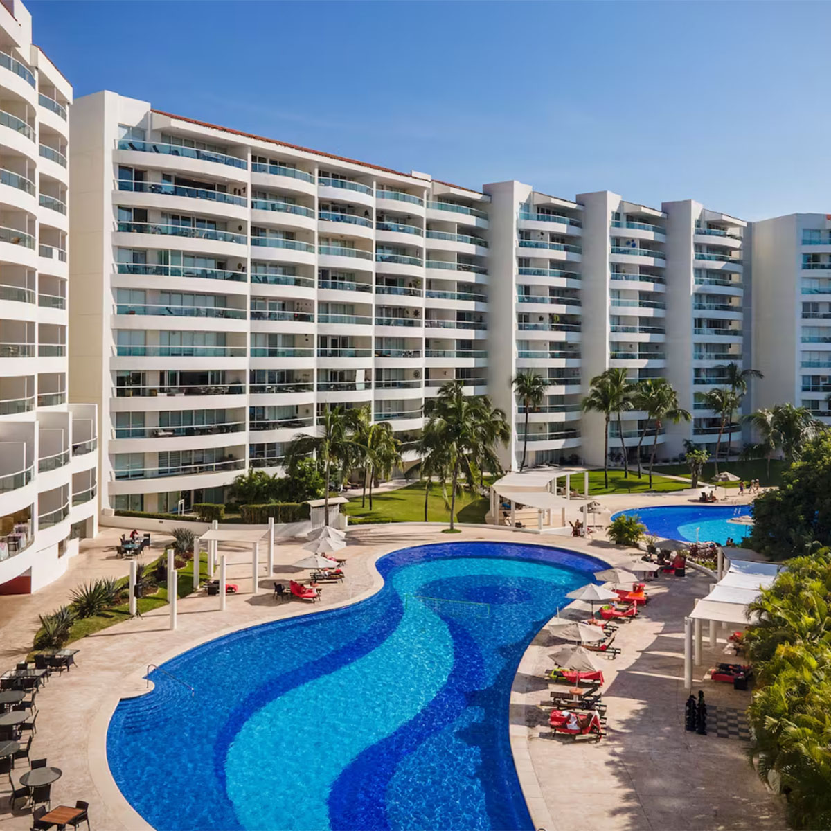 A swimming pool and lounge chairs at a resort in Puerto Vallarta.