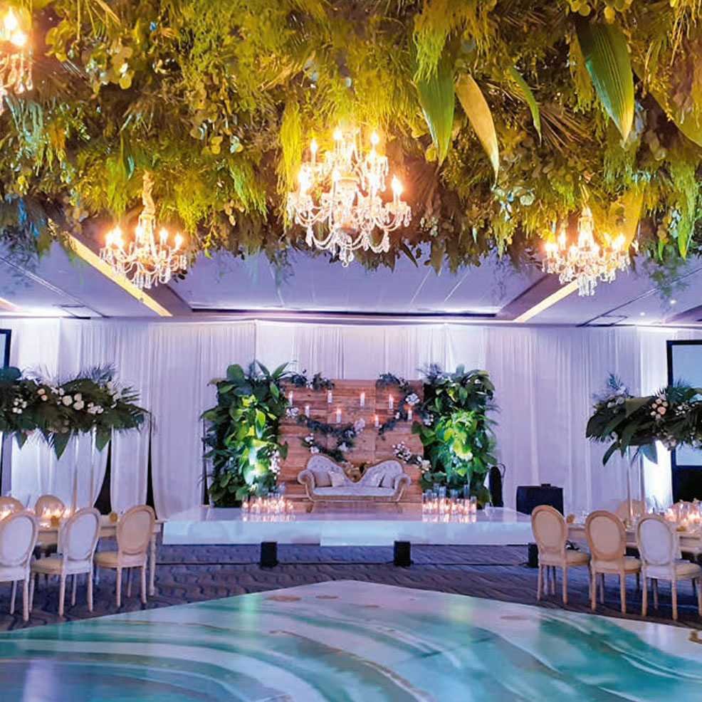 A wedding reception set up with a tropical theme.