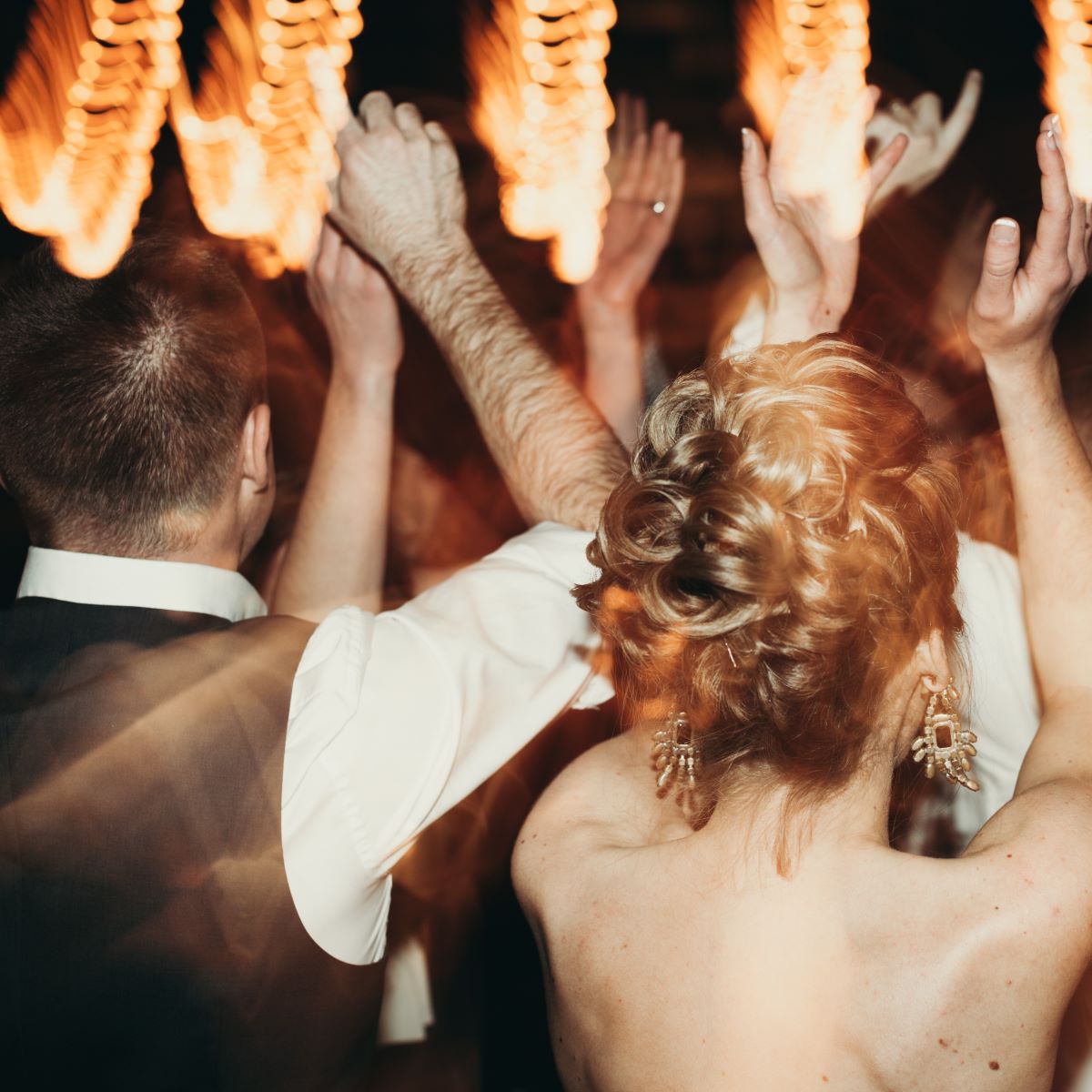 A bride and groom dancing at their wedding reception, showcasing one of the many activities for guests to enjoy.