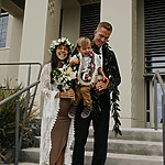 Courthouse wedding with Hawaiian bride and groom on the steps of a building.