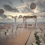 A wedding ceremony set up on a rooftop overlooking the ocean, creating a unique venue for the special day.