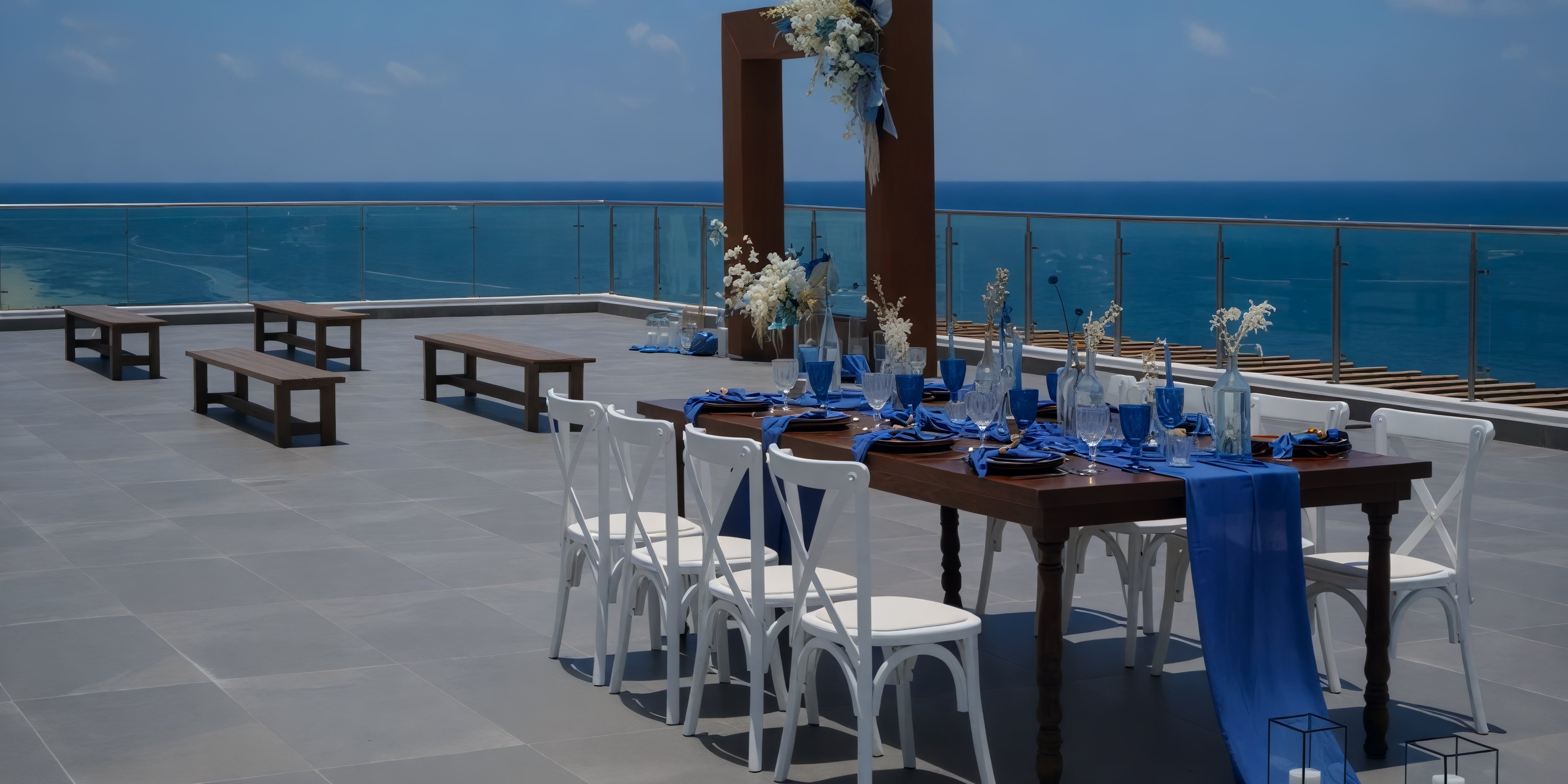 Experience a dream destination wedding by dining with a stunning sea view at Margaritaville Island Reserve Riviera Maya, where elegant blue and white decor enhances the occasion.