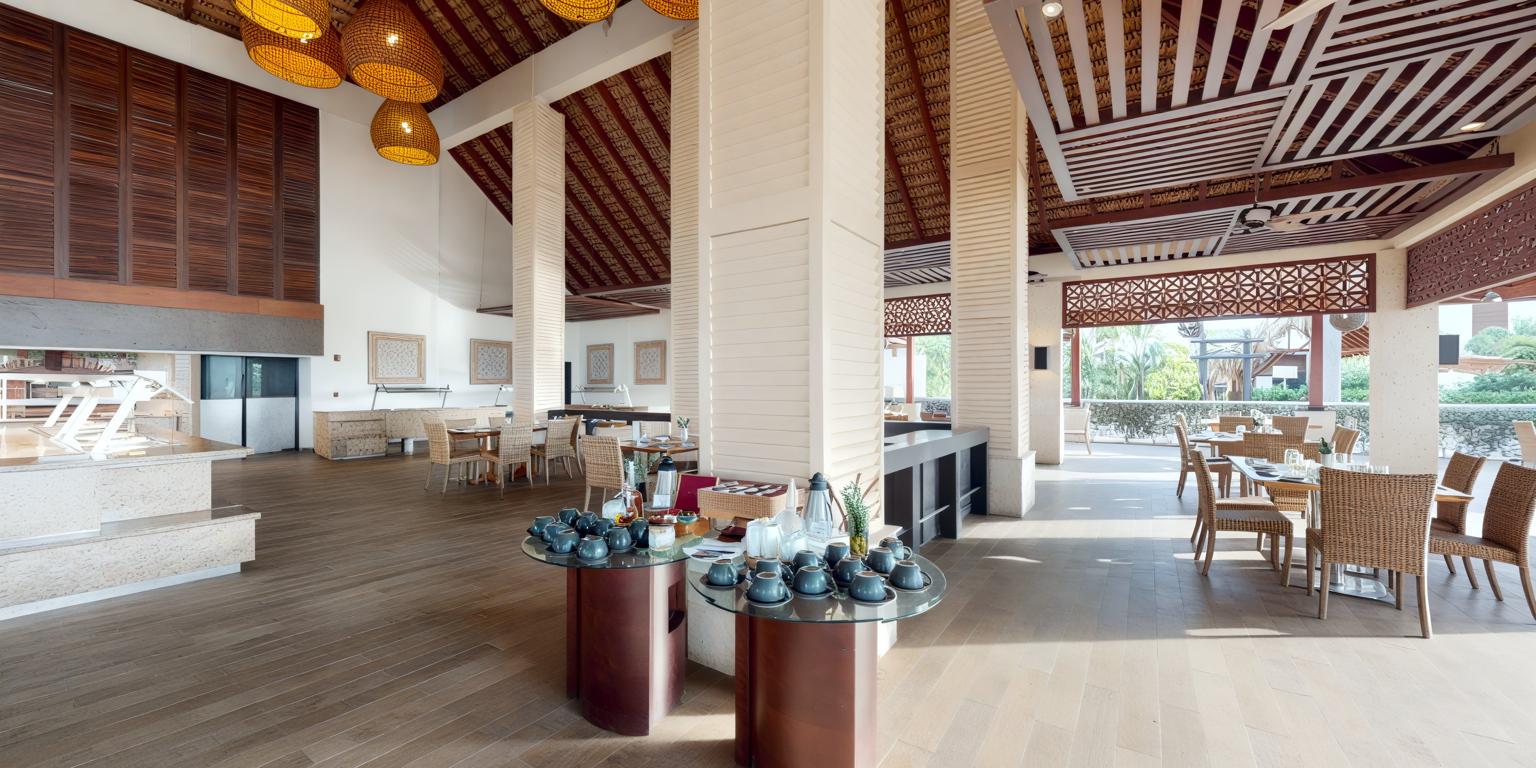 A capacious restaurant interior adorned with wooden decor, perfectly set tables ready to host a destination wedding.