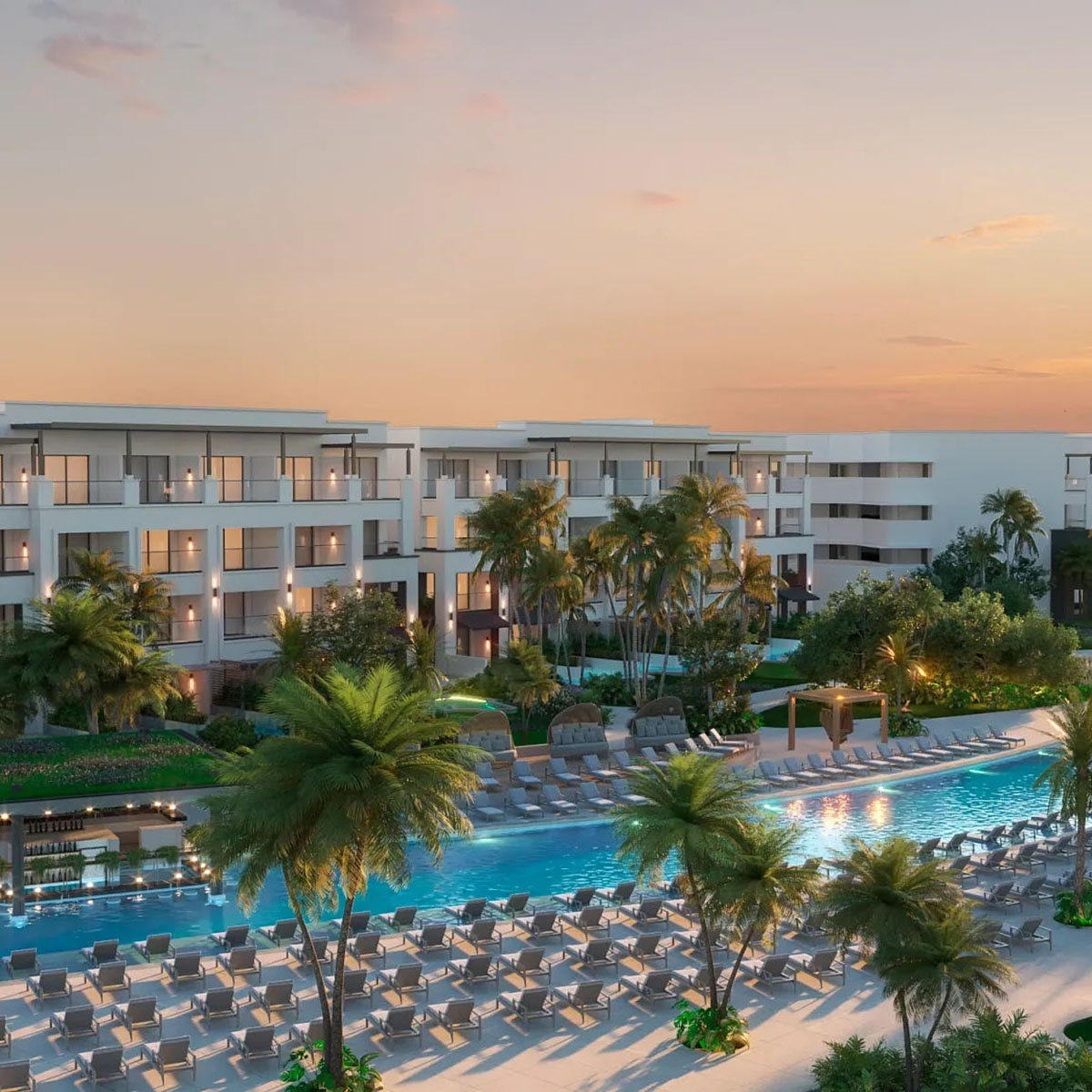Modern Secrets Tides with pool area surrounded by palm trees at sunset.