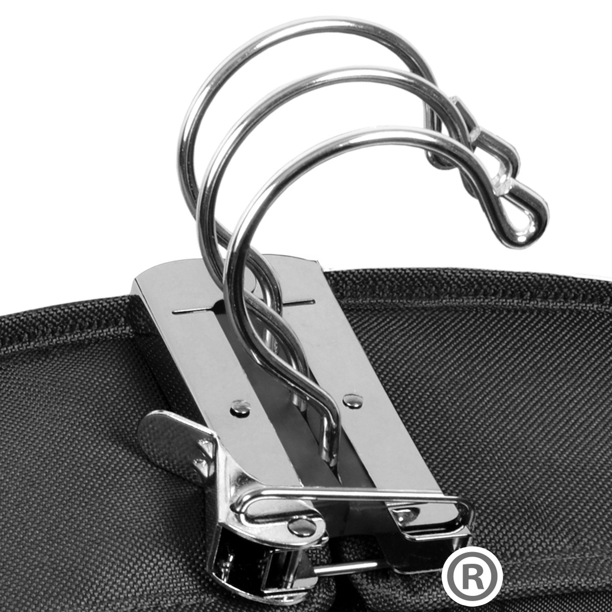 Close-up of a shiny metallic three-ring binder mechanism attached to a black fabric surface, showing the open rings and clasp—ideal for organizing your lists and tips for packing and transporting wedding dresses and suits.