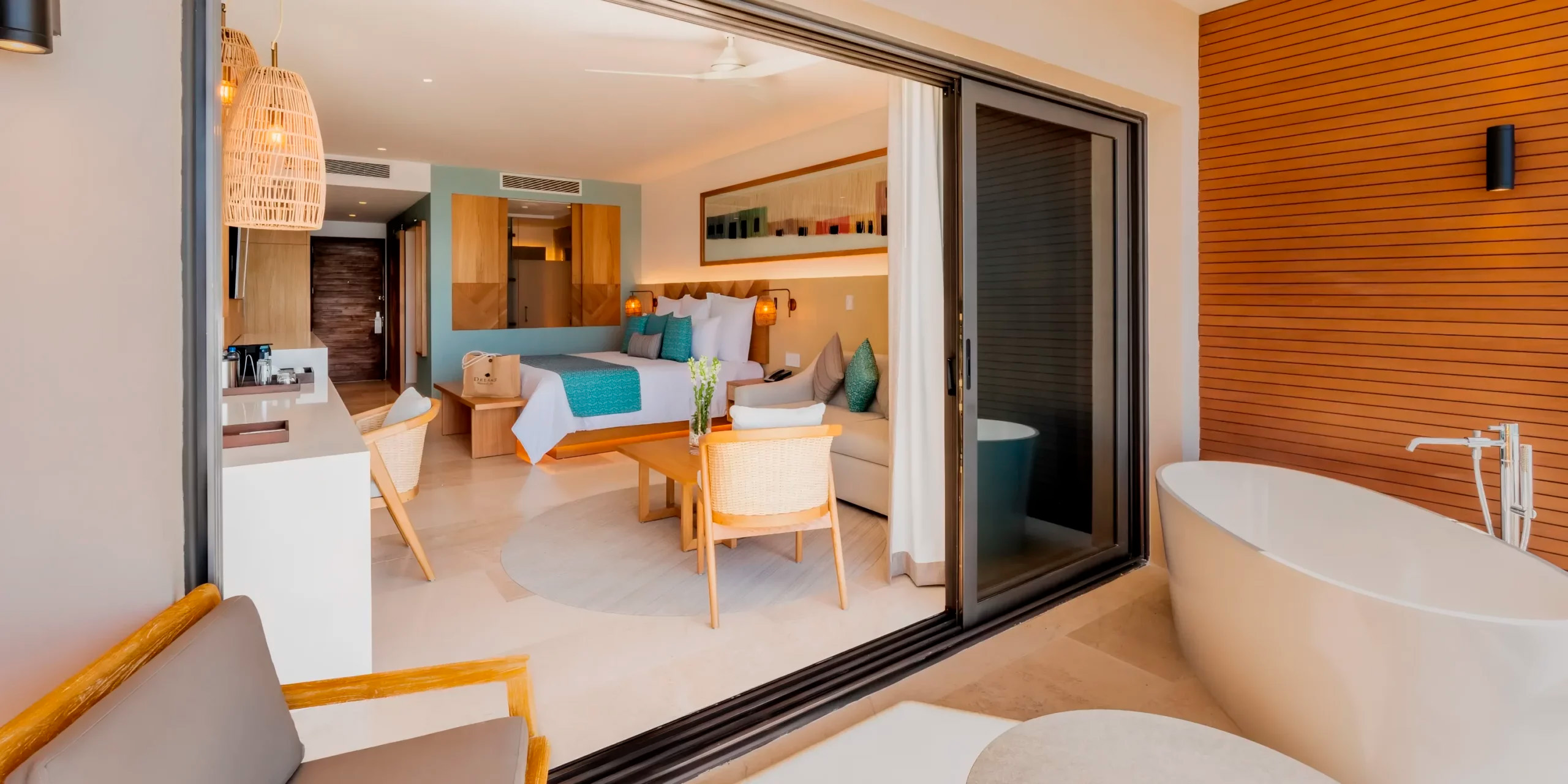 Dreams Estrella del Mar Mazatlan offers the perfect accommodation for a destination wedding, featuring a room with a terrace tub, elegant sliding doors, and a comfortable seating area.