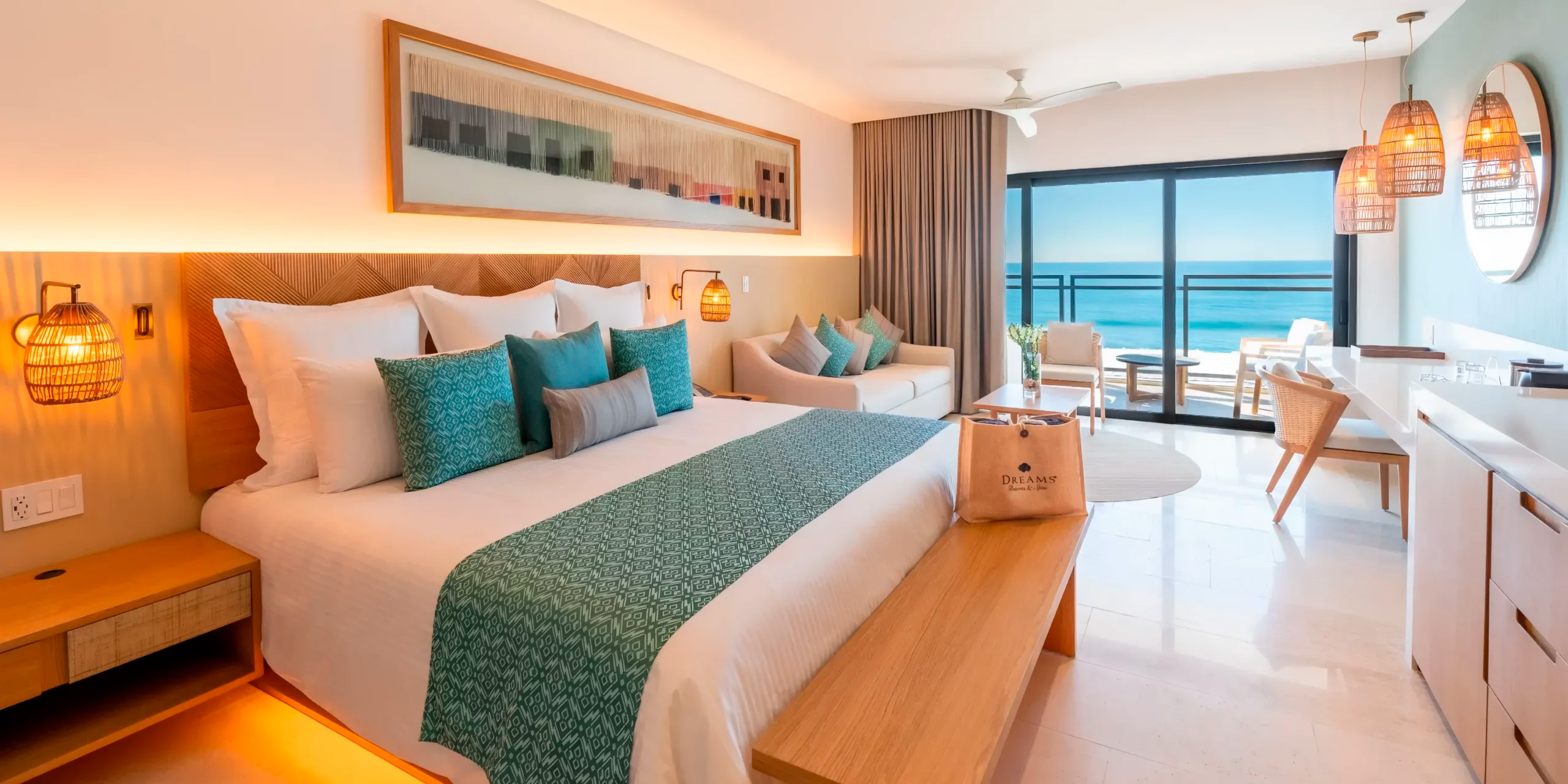 Experience the magic of a destination wedding at Stylish Dreams Estrella del Mar in Mazatlan, where your hotel room features a large bed, comfortable sofa, and a balcony that offers breathtaking ocean views.