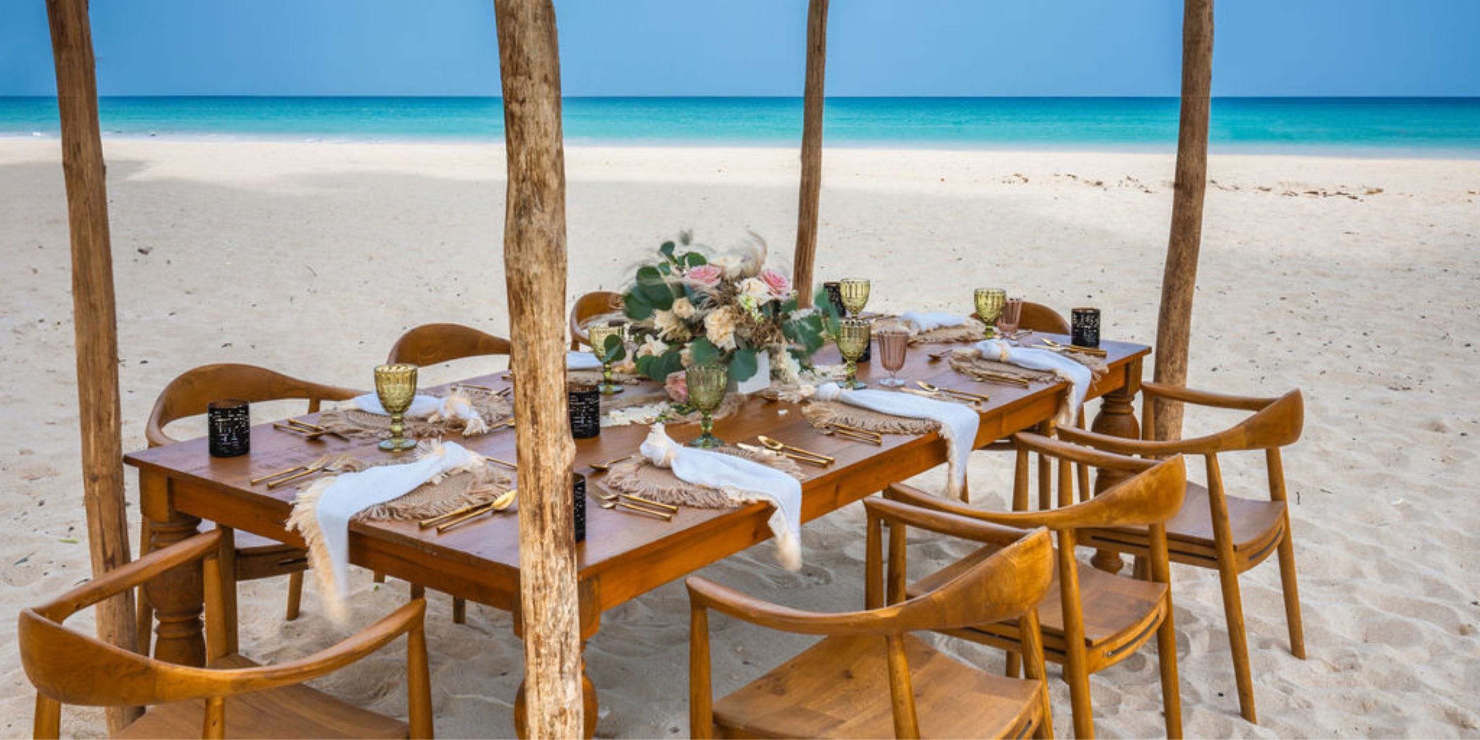 Hilton Cancun Mar Caribe: Destination wedding dining table under a canopy, overlooking the ocean.