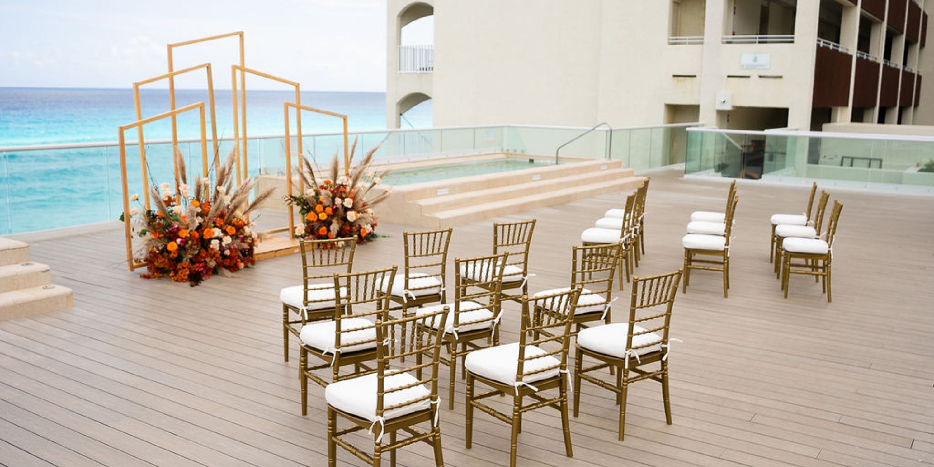 Destination wedding setup at Hilton Cancun Mar Caribe featuring gold chairs and stunning ocean views.