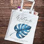 Canvas tote for a destination wedding, featuring a blue leaf print and welcome message.