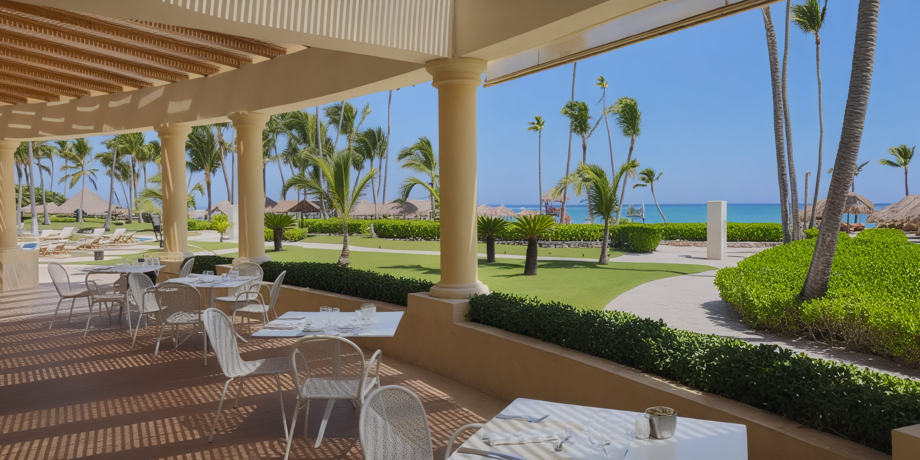 Imagine hosting your dream destination wedding at JOIA Bavaro, where you and your guests can dine at elegant white tables and chairs set under a clear blue sky with breathtaking ocean views.