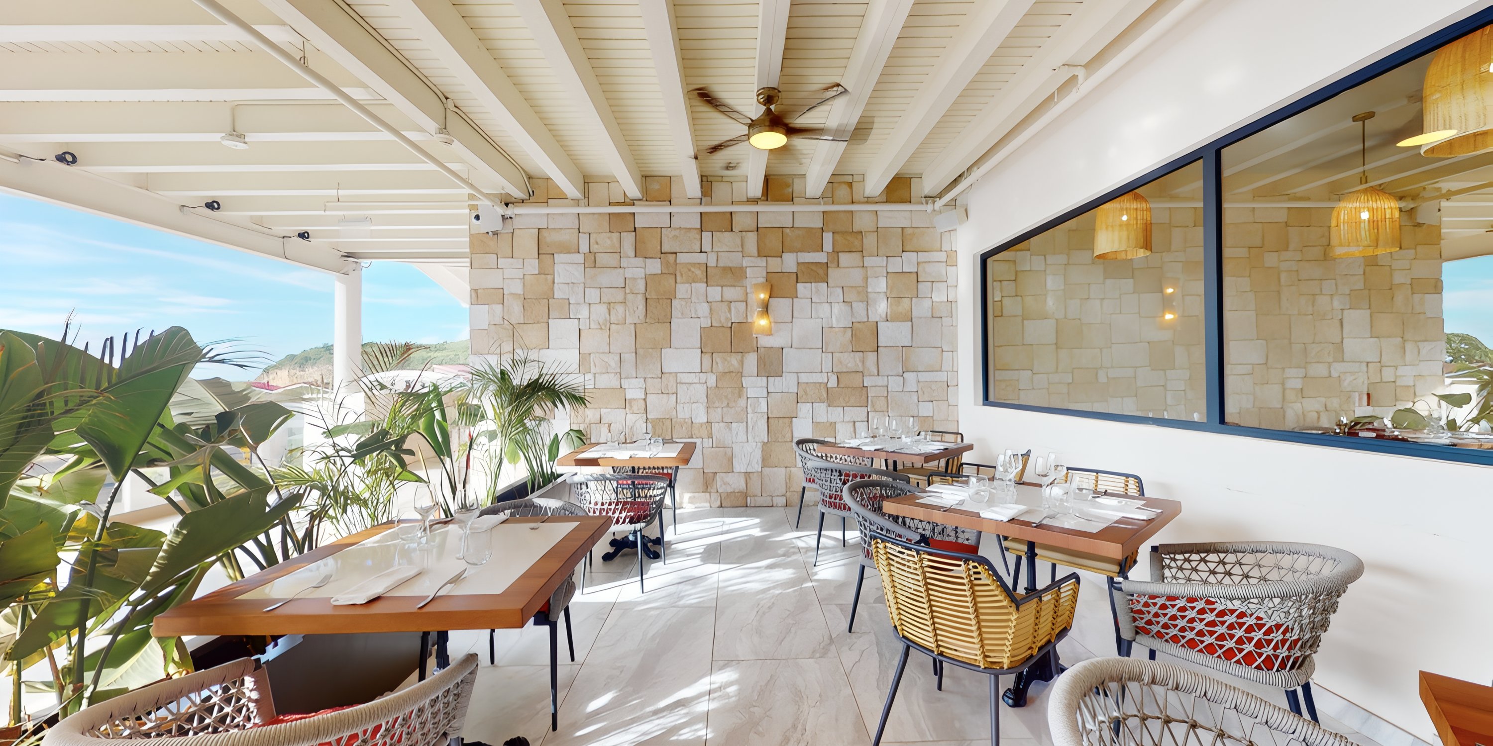 Royalton Chic Antigua patio, ideal for a destination wedding, features wicker chairs and stone accents.