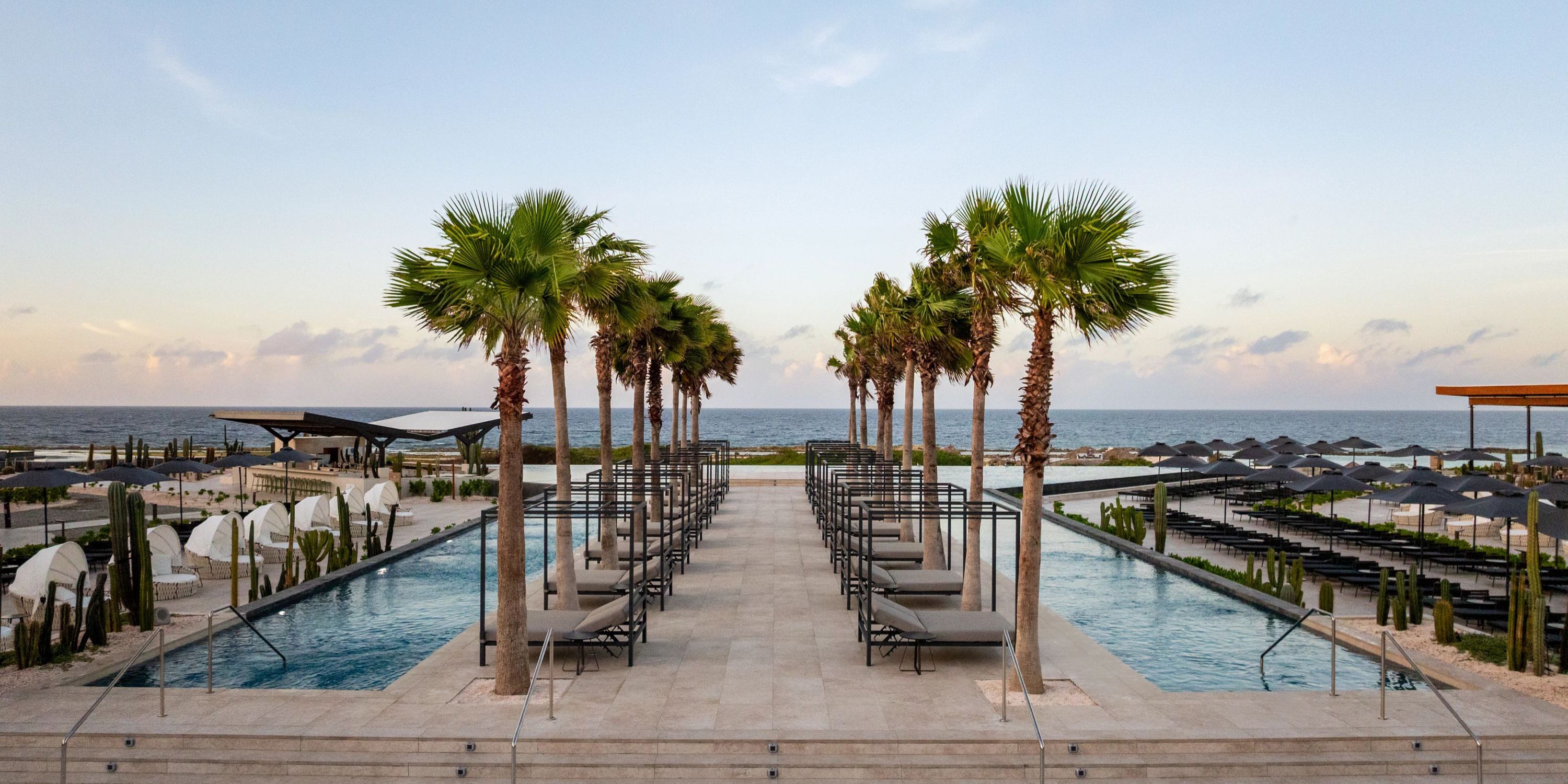 Oceanfront pool deck with lounge chairs at Secrets Baby Beach Aruba, perfect for a destination wedding.