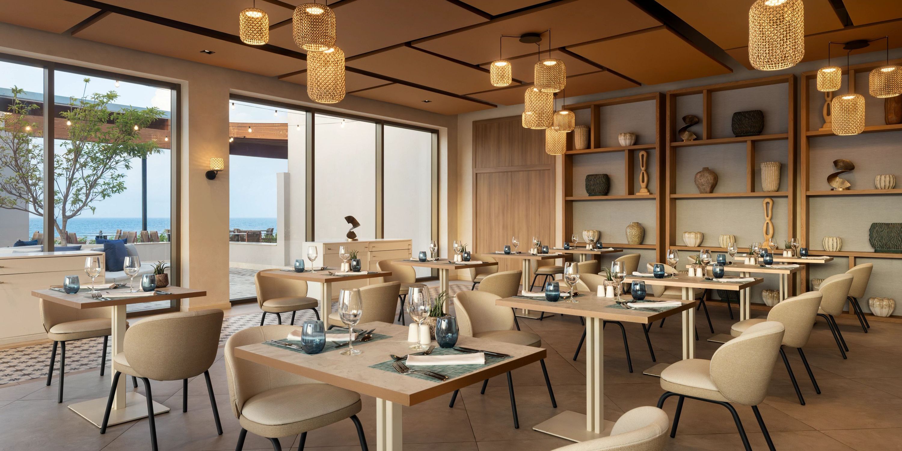 Secrets Baby Beach Aruba offers a stylish dining area with beige chairs, perfect for a destination wedding.
