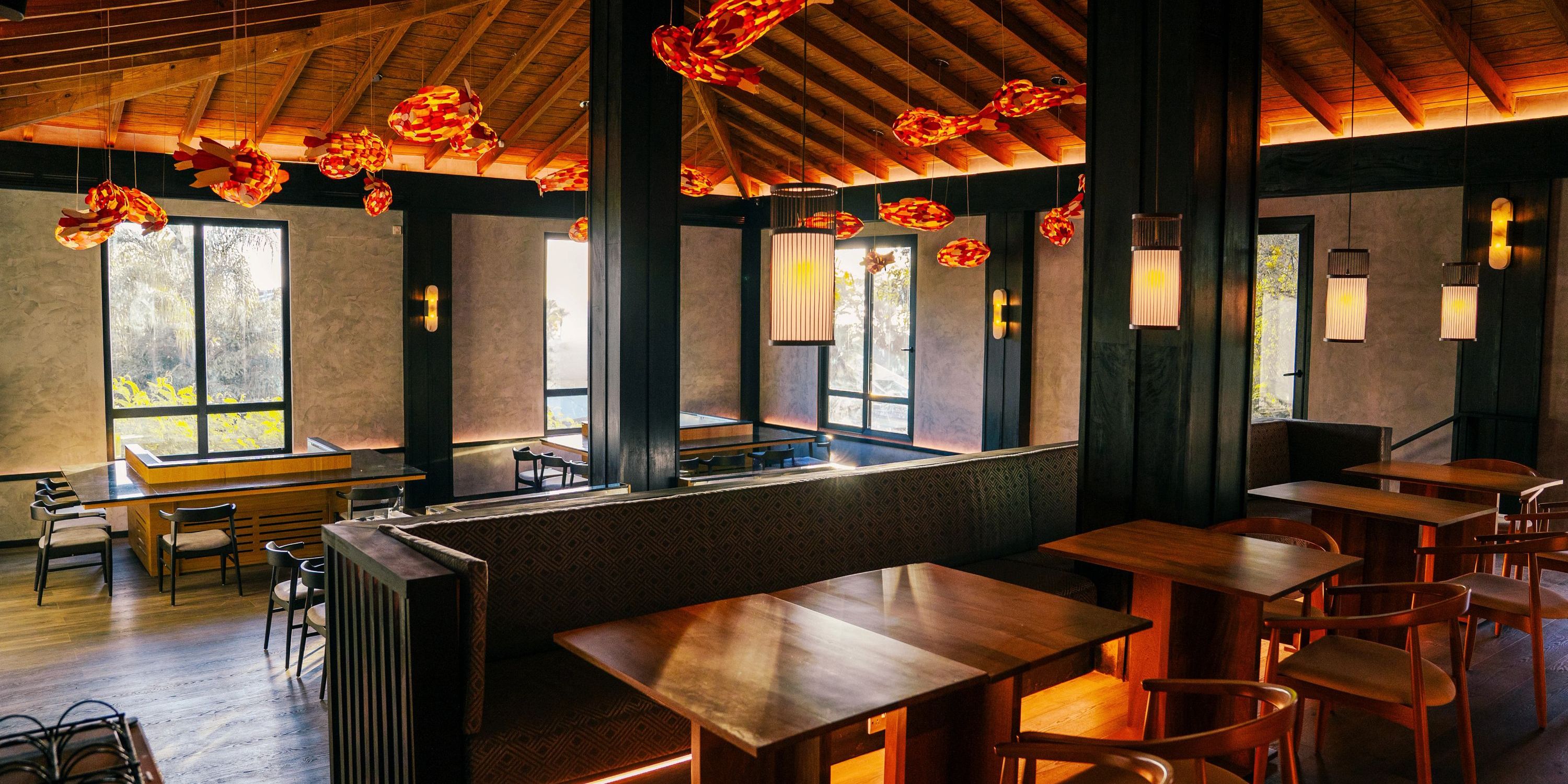 Secrets St Lucia wedding venue with wooden tables, chairs, and artistic red ceiling lights.