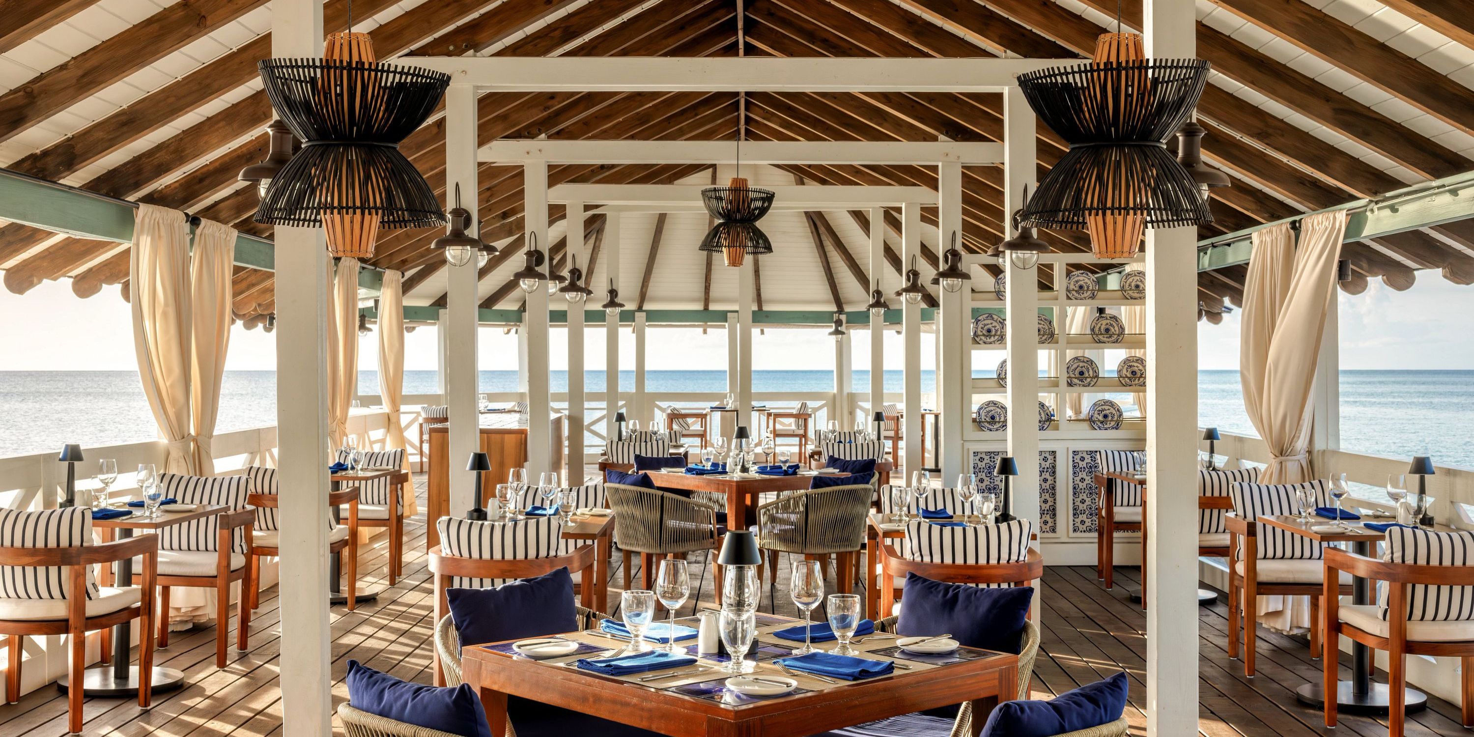 Secrets St Lucia: open-air seaside dining with wooden ceiling—perfect for a romantic destination wedding.
