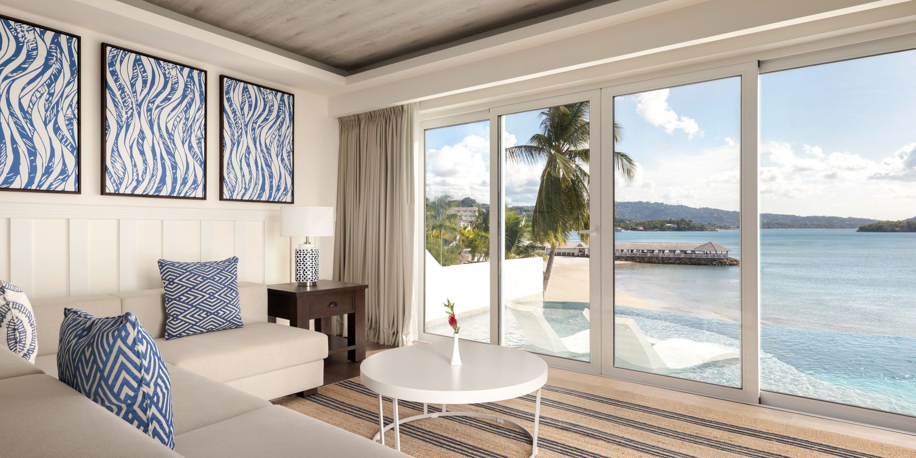 Secrets St Lucia: Modern beachfront living room with blue decor, perfect for a destination wedding.