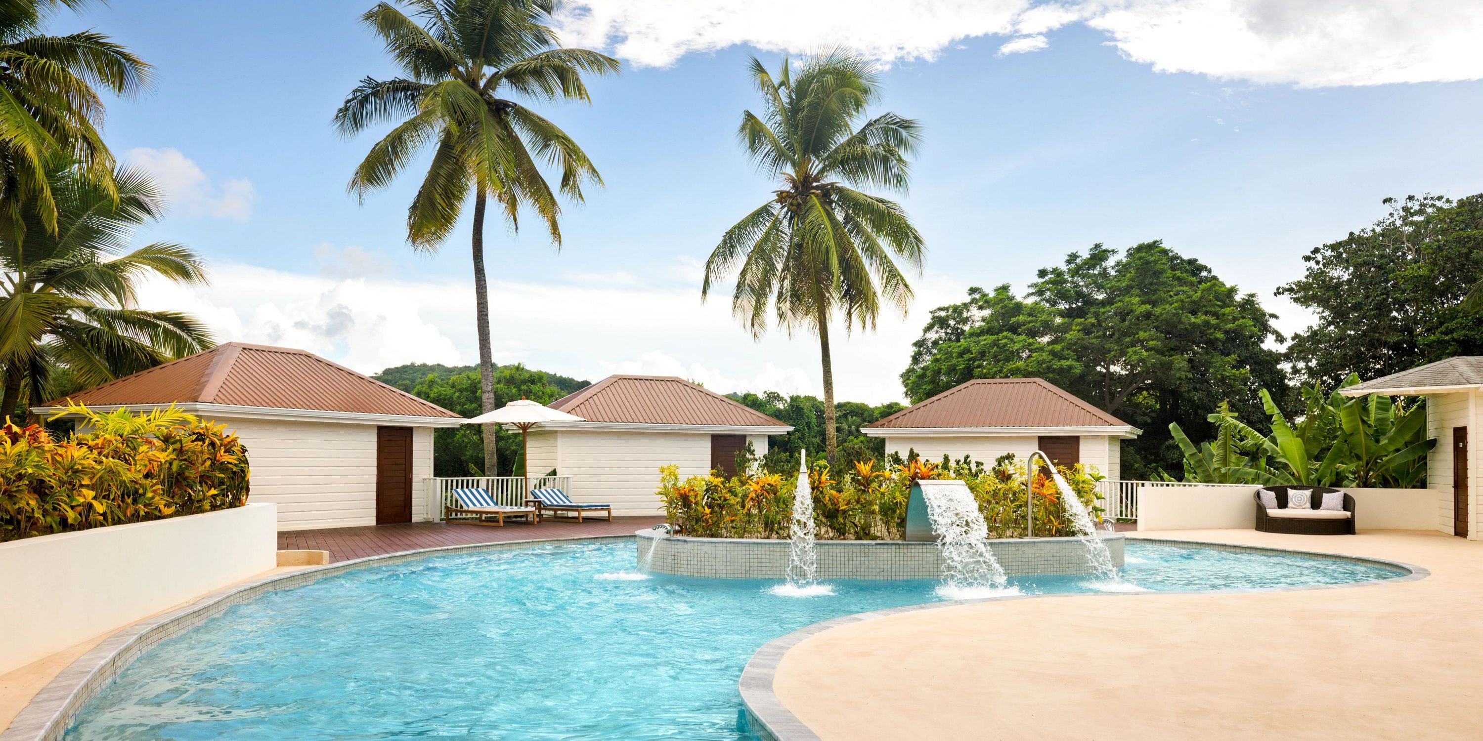 Secrets St Lucia offers a picturesque outdoor pool with fountains, palm trees, and cabanas—ideal for a destination wedding.