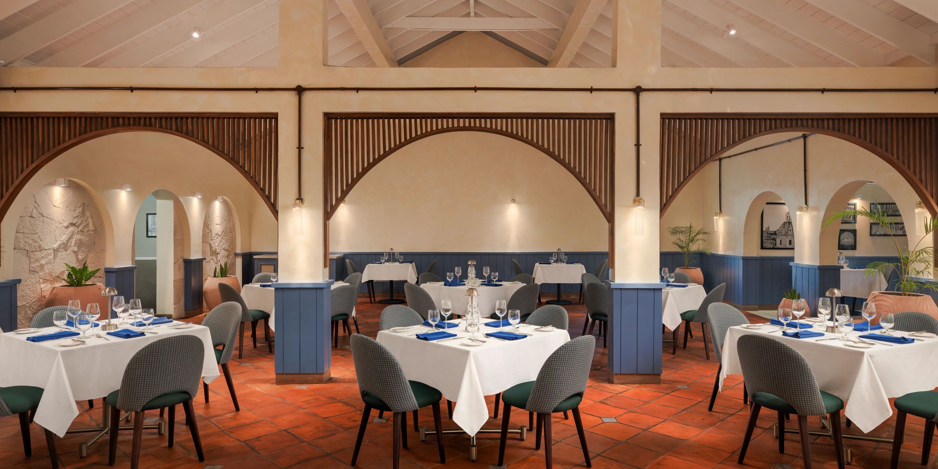 Secrets St Lucia offers an elegant restaurant, ideal for a destination wedding, with arched partitions and neatly set tables.