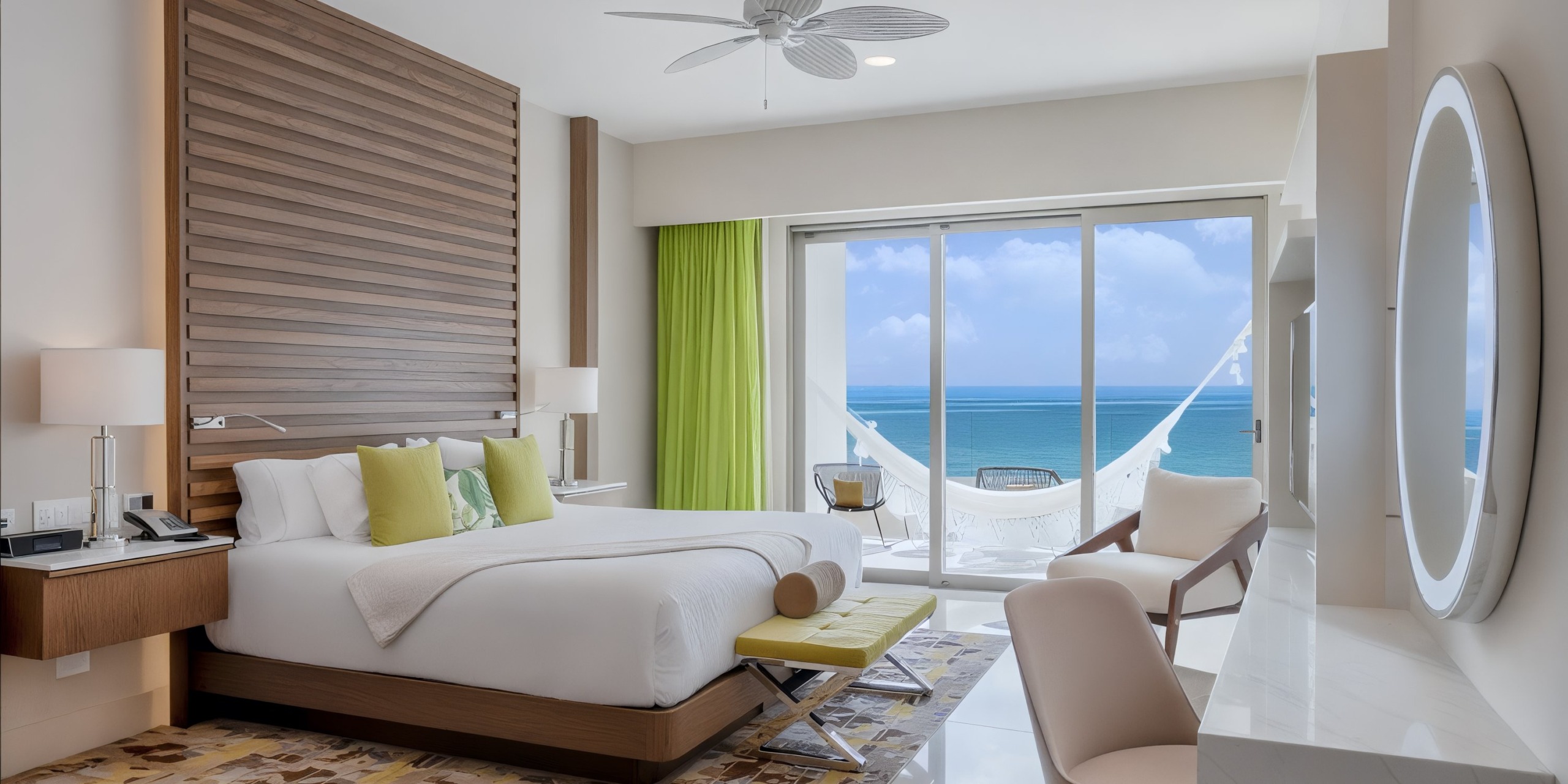 Experience the modern Garza Blanca Cancun hotel room, featuring a double bed, elegant wooden accents, a hammock on the balcony, and breathtaking ocean views.