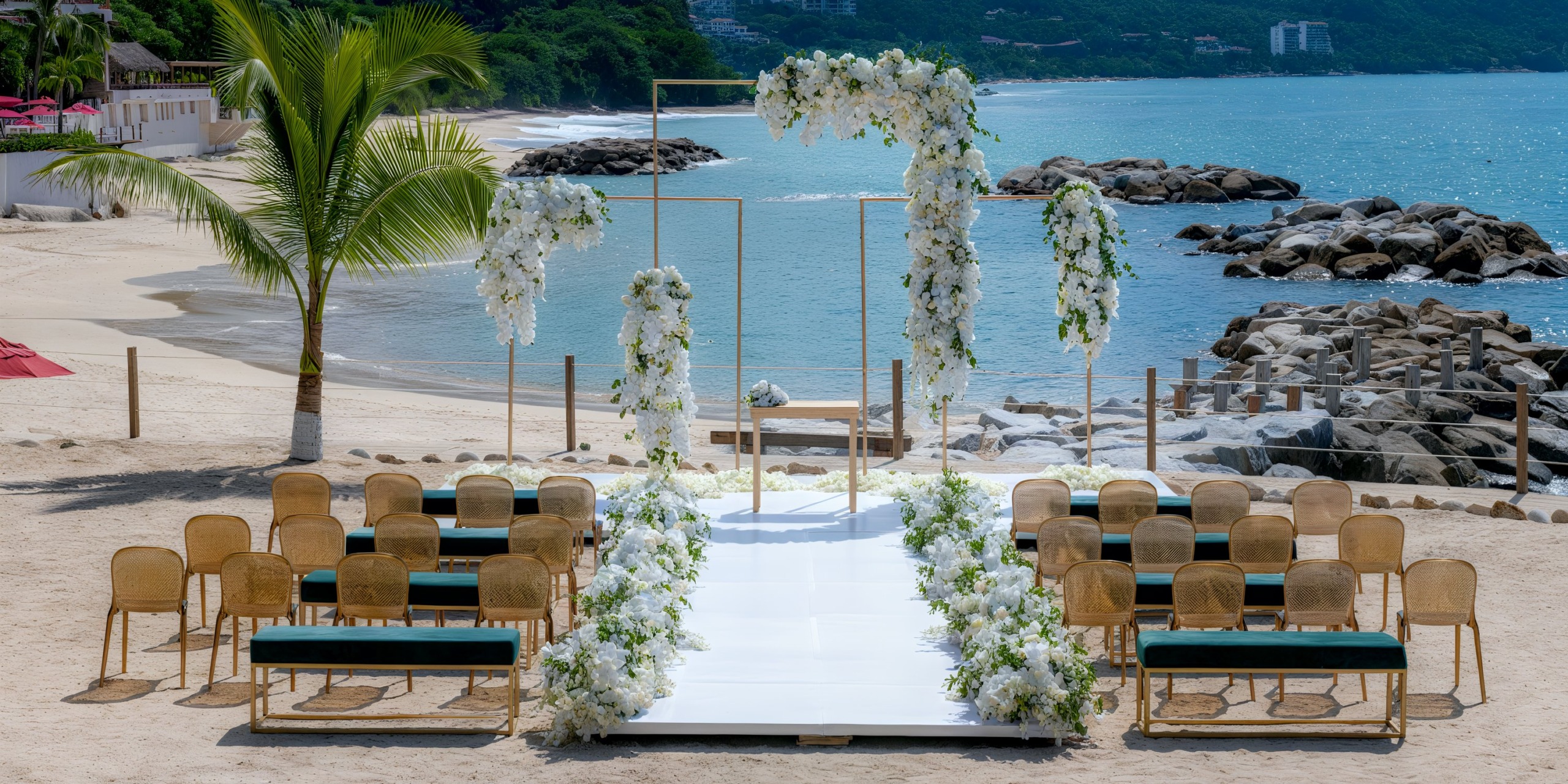 Experience a stunning beachfront wedding setup at the Hilton Vallarta Riviera All-Inclusive Resort, featuring elegant floral decorations, arranged chairs, and a pristine white aisle overlooking the ocean.