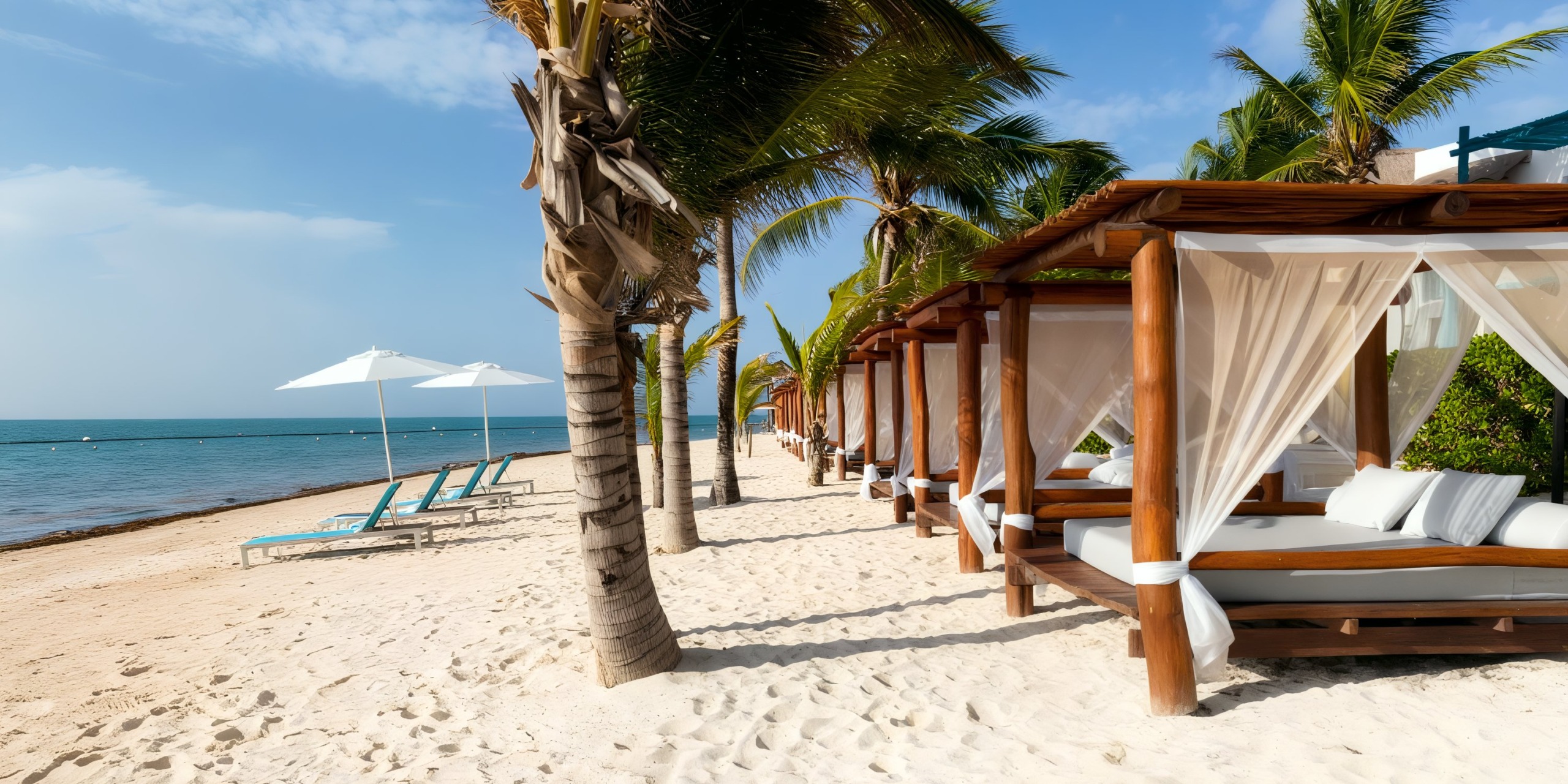 Margaritaville Island Reserve Resort Riviera Cancun features a tropical beach scene with palm trees, sun loungers, and cabanas adorned with white curtains along the shoreline under a clear blue sky.