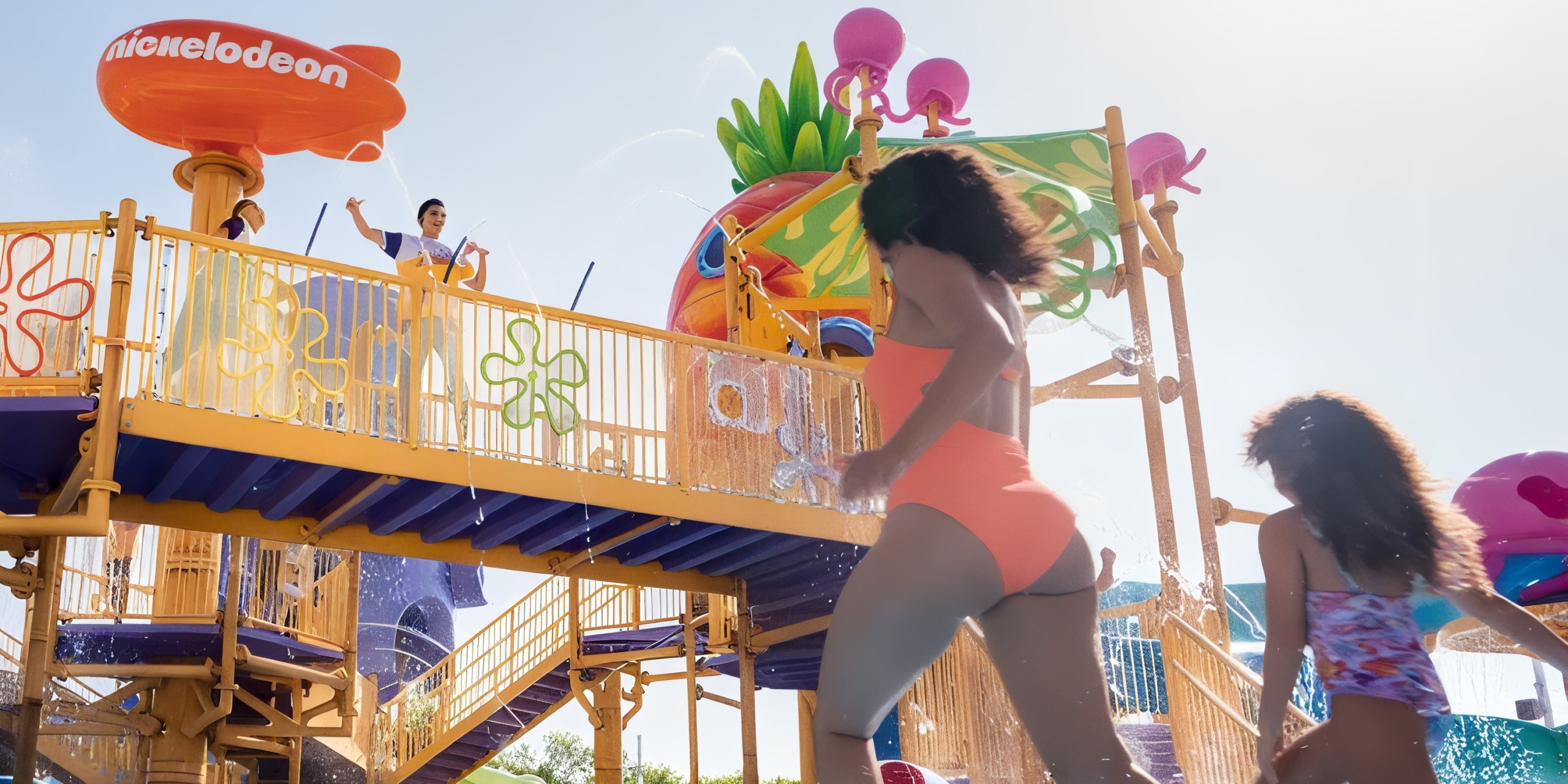 Visitors at Nickelodeon Hotels & Resorts Riviera Maya delight in a vibrant water play structure complete with slides and splash features.