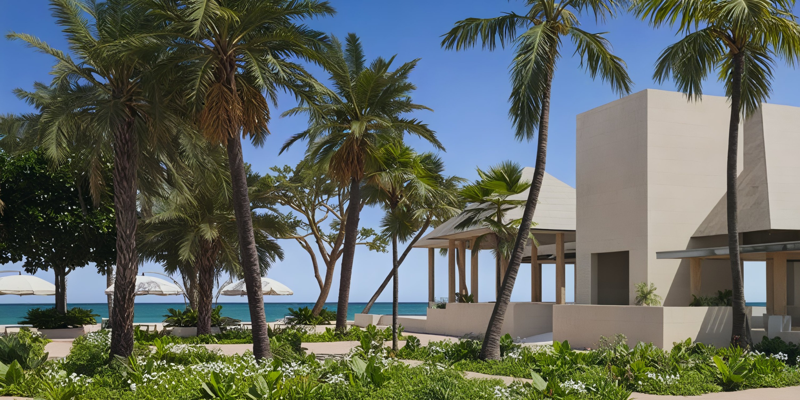 Discover the Princess Grand Jamaica, a contemporary beachfront resort featuring palm trees, elegant white buildings, and breathtaking ocean views.