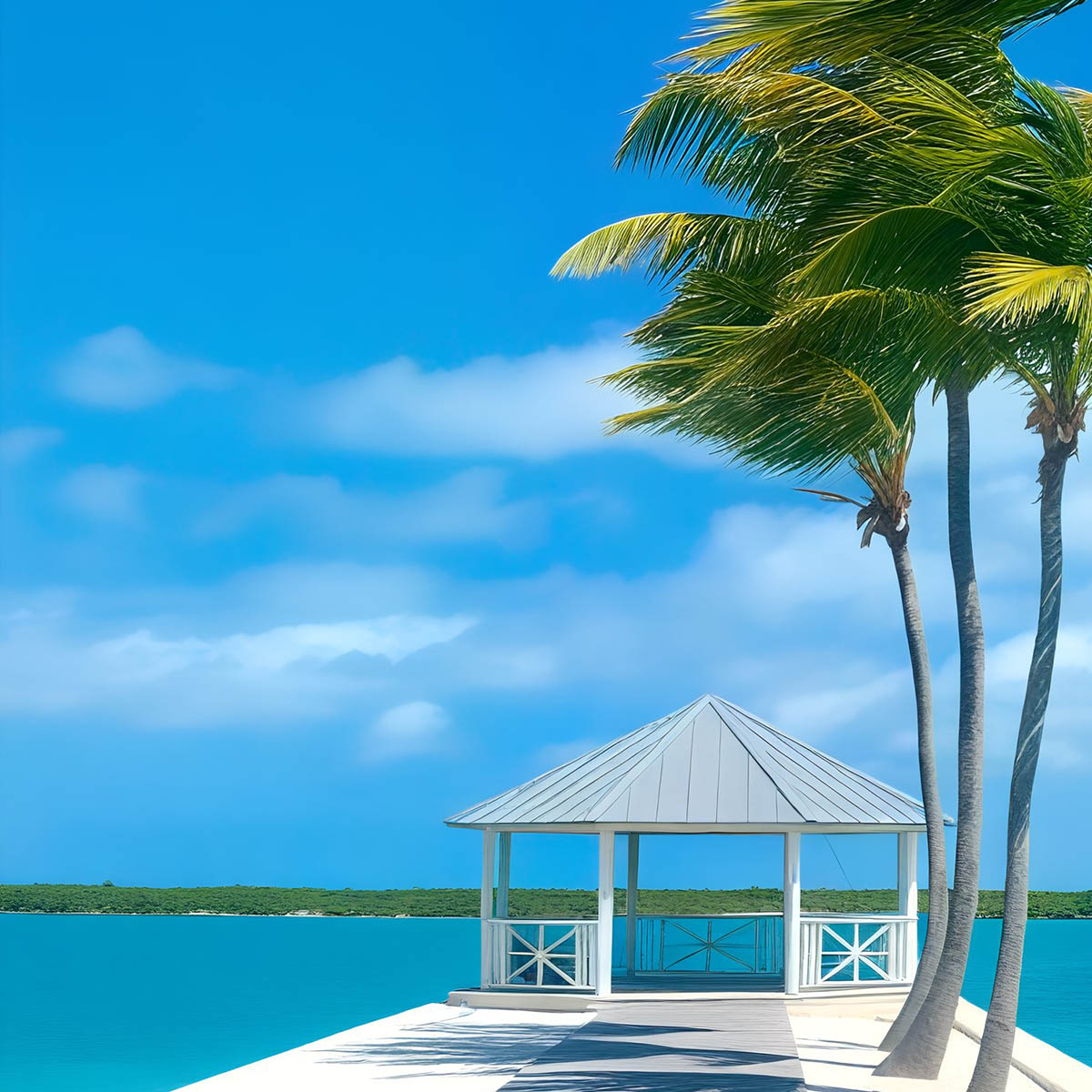 A white gazebo on a pier over turquoise water, with palm trees swaying under a clear blue sky.