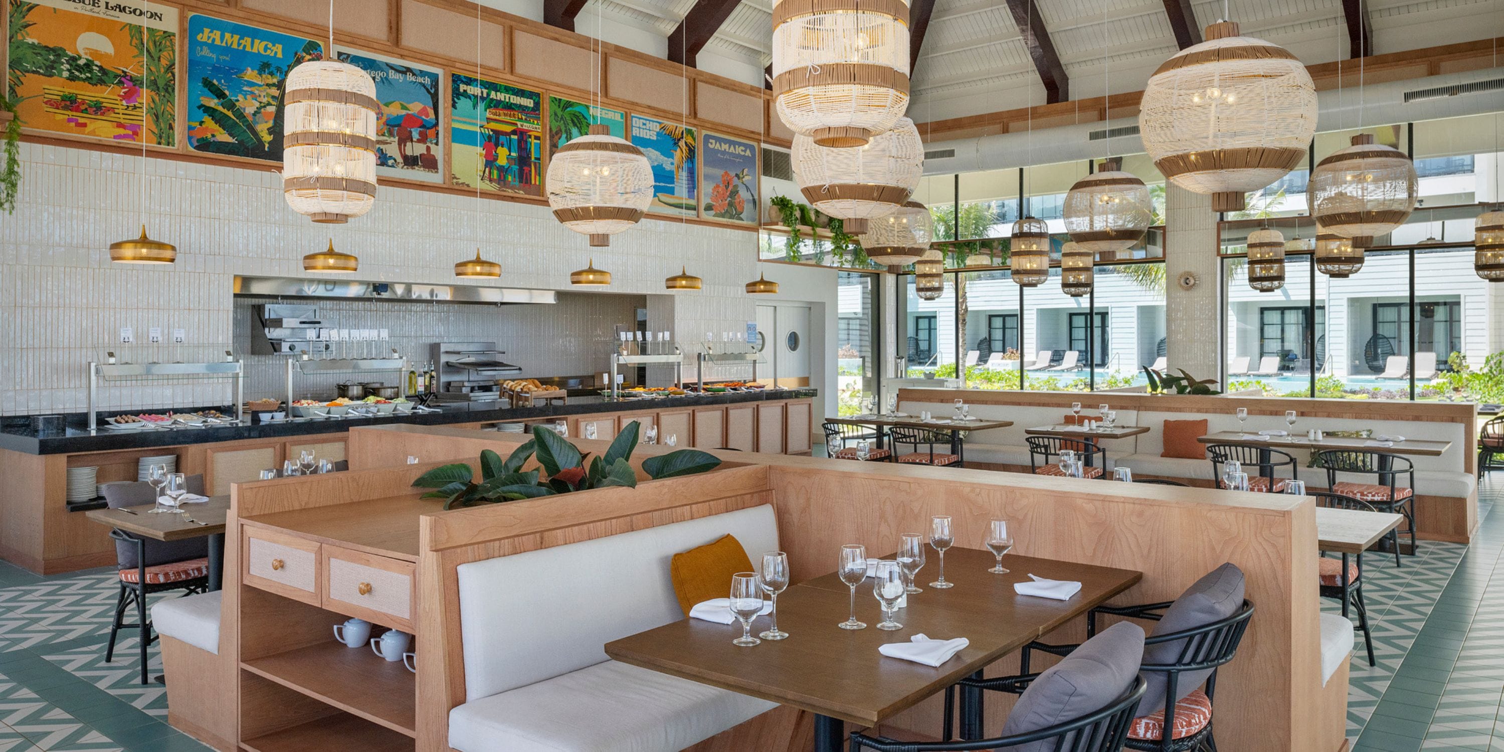 Ocean Eden Bay’s modern interiors with wooden booths and set tables create a chic destination wedding vibe.