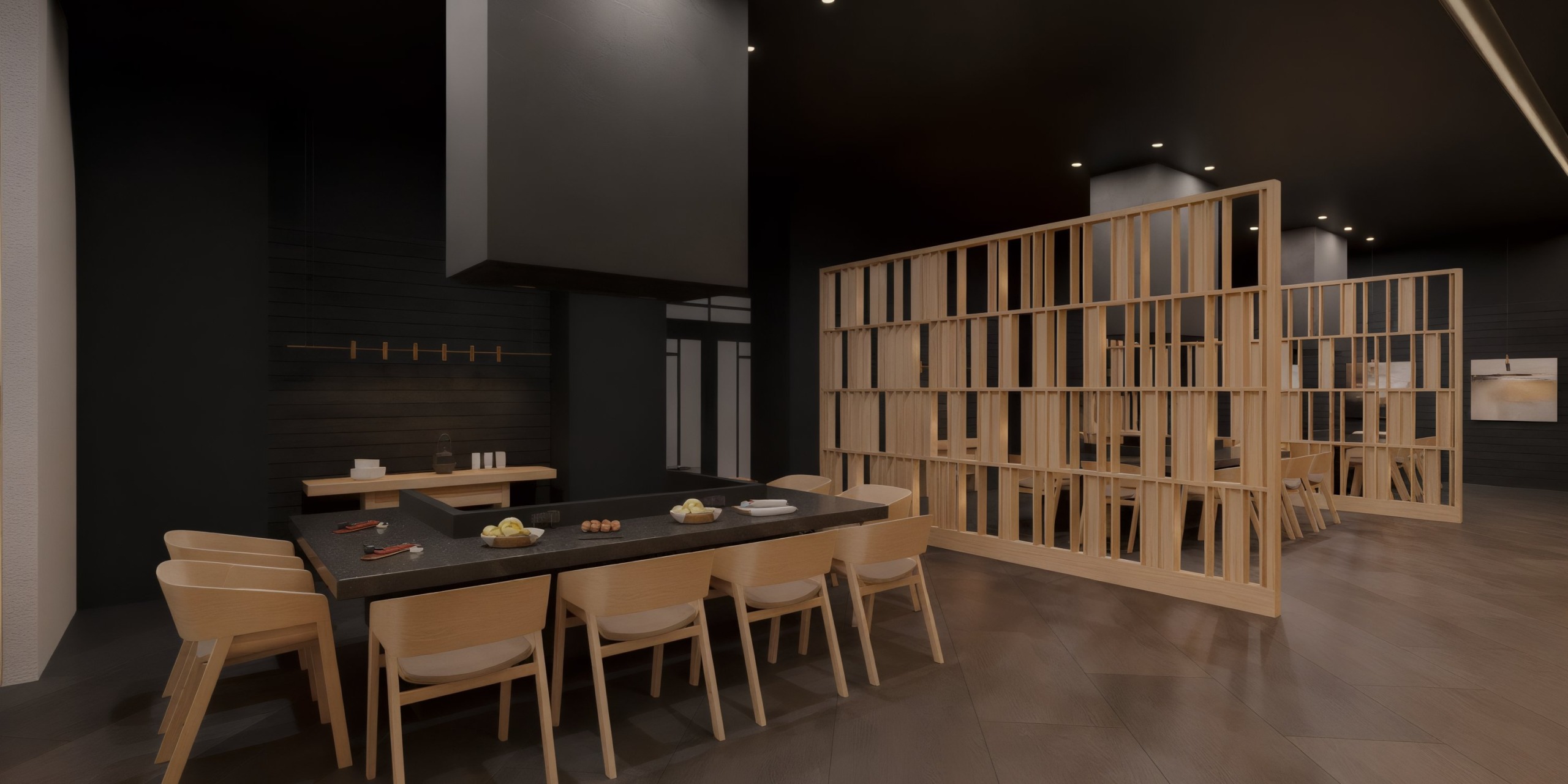 The Wyndham Alltra Punta Cana dining area features a dark table, light wood chairs, and minimalistic decor. A wooden partition elegantly divides the space, while dim lighting enhances the cozy atmosphere.
