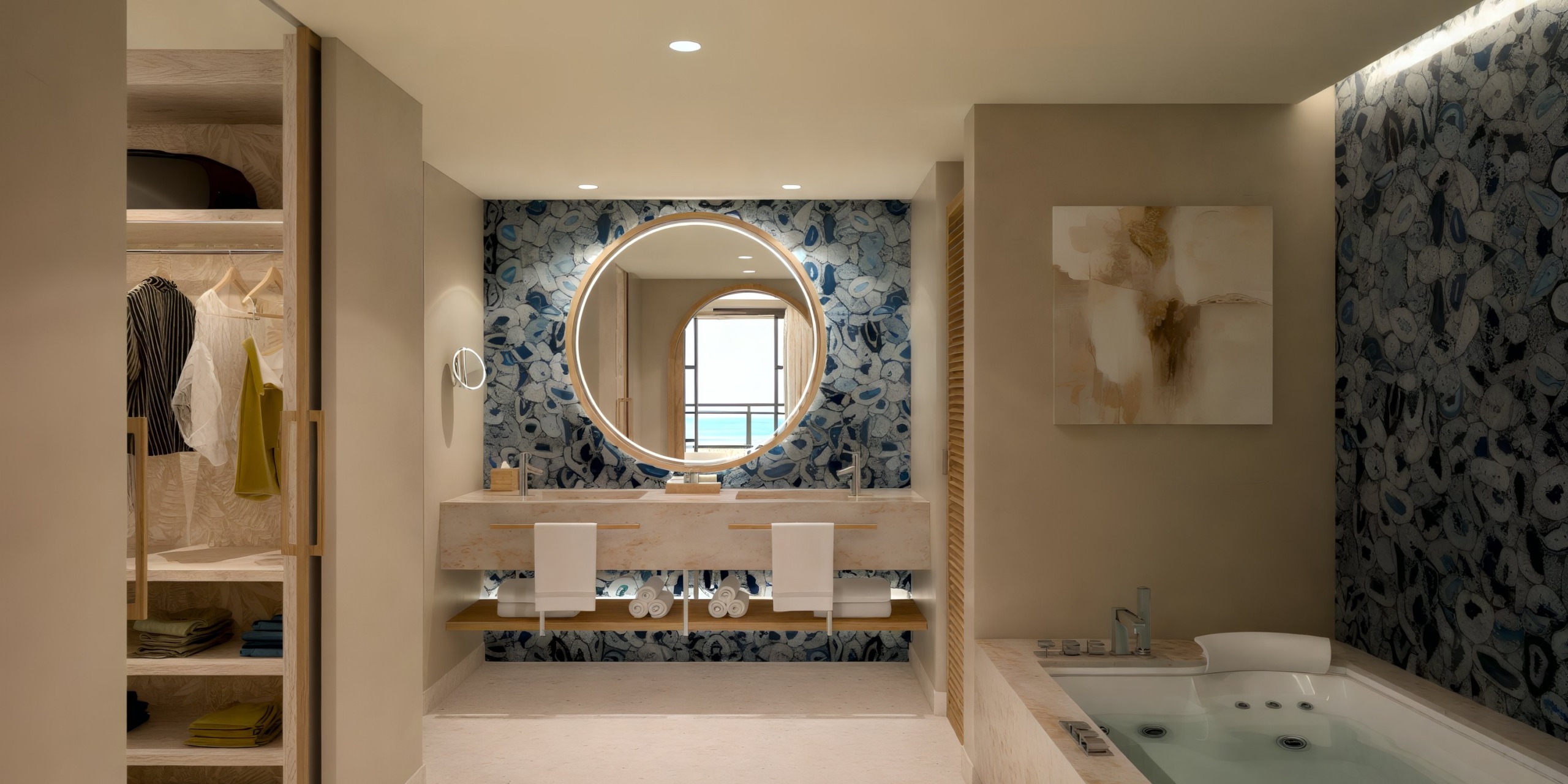 Discover the modern bathroom at Dreams Playa Esmeralda, perfect for your destination wedding stay, featuring a large mirror, twin sinks, a spacious closet, and a luxurious bathtub.