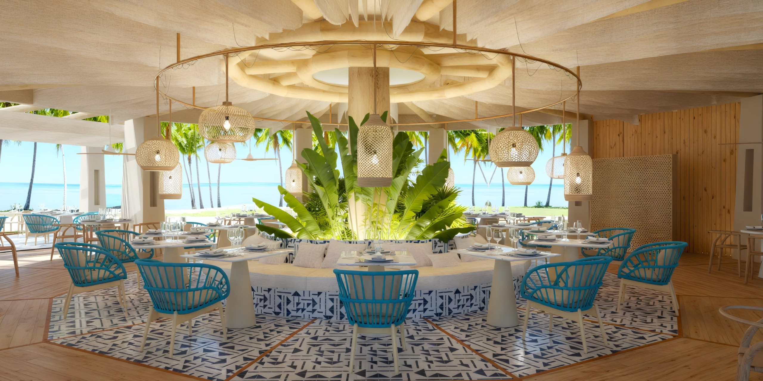 Dreams Playa Esmeralda: a tropical eatery featuring blue chairs, pendant lights, and a central plant, perfect for a destination wedding setting.