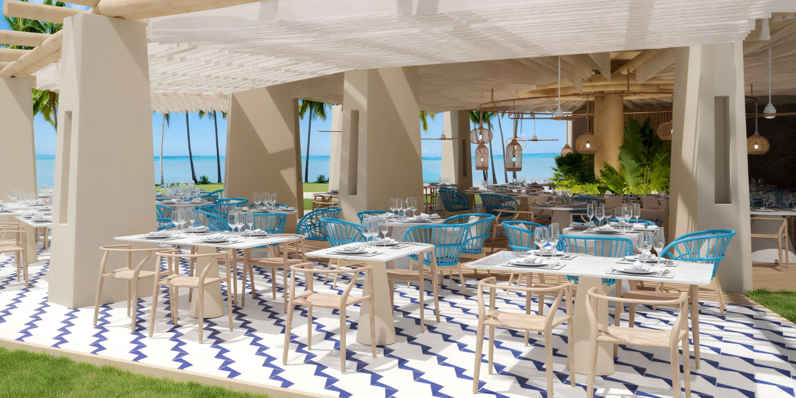 Dreams Playa Esmeralda provides a stunning outdoor dining area with blue chairs and white tables, perfect for a destination wedding with breathtaking ocean views.