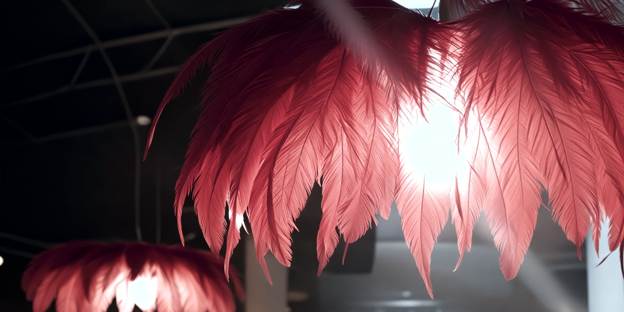 Scarlet feathered lampshades emit a gentle glow, perfect for creating an enchanting atmosphere at a destination wedding.