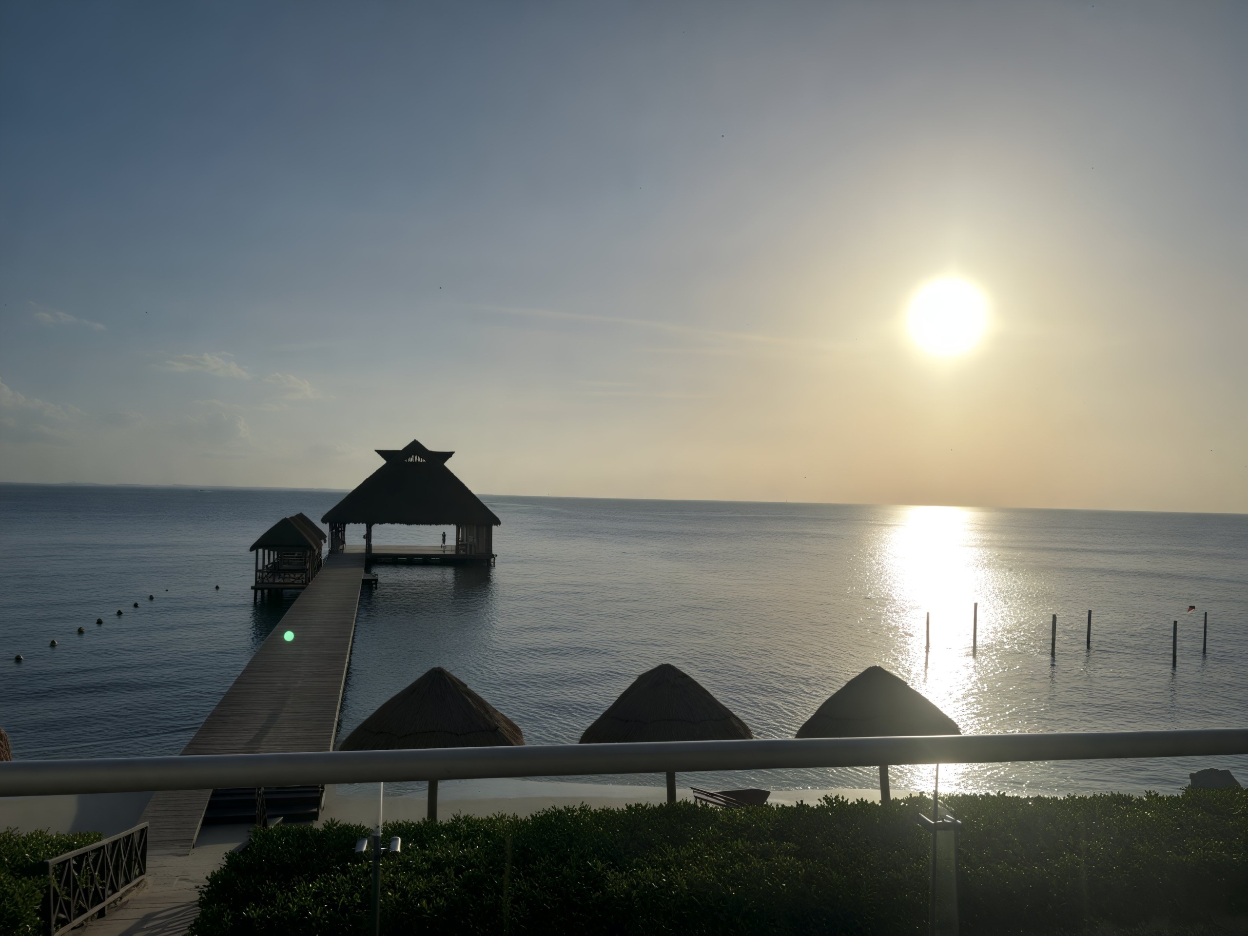 A picturesque sunset with a pier and gazebo in the foreground, featuring "Sheneka and Andre" as part of an idyllic destination wedding scene.