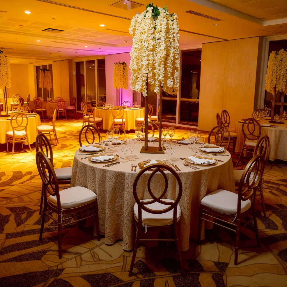 Sophisticated wedding banquet hall featuring round tables adorned with floral centerpieces, perfect for a destination wedding.
