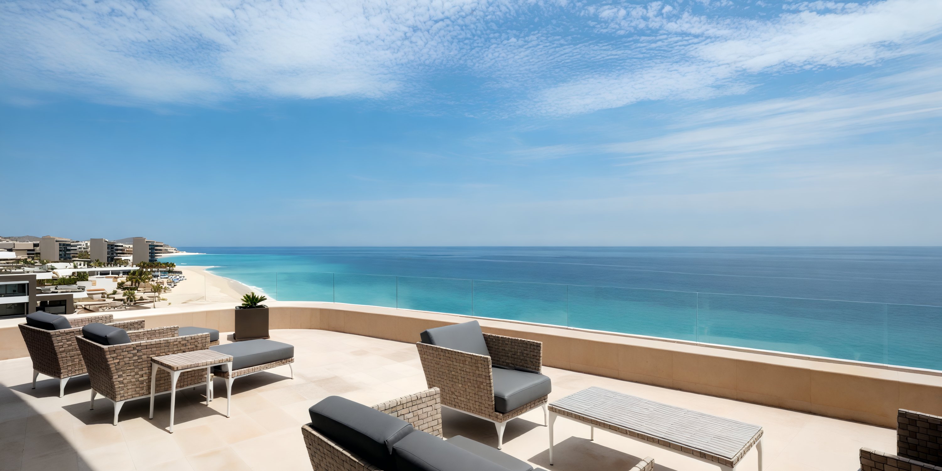 The stunning patio at Garza Blanca Los Cabos, with its breathtaking ocean view set against a clear blue sky, provides the perfect backdrop for a destination wedding.