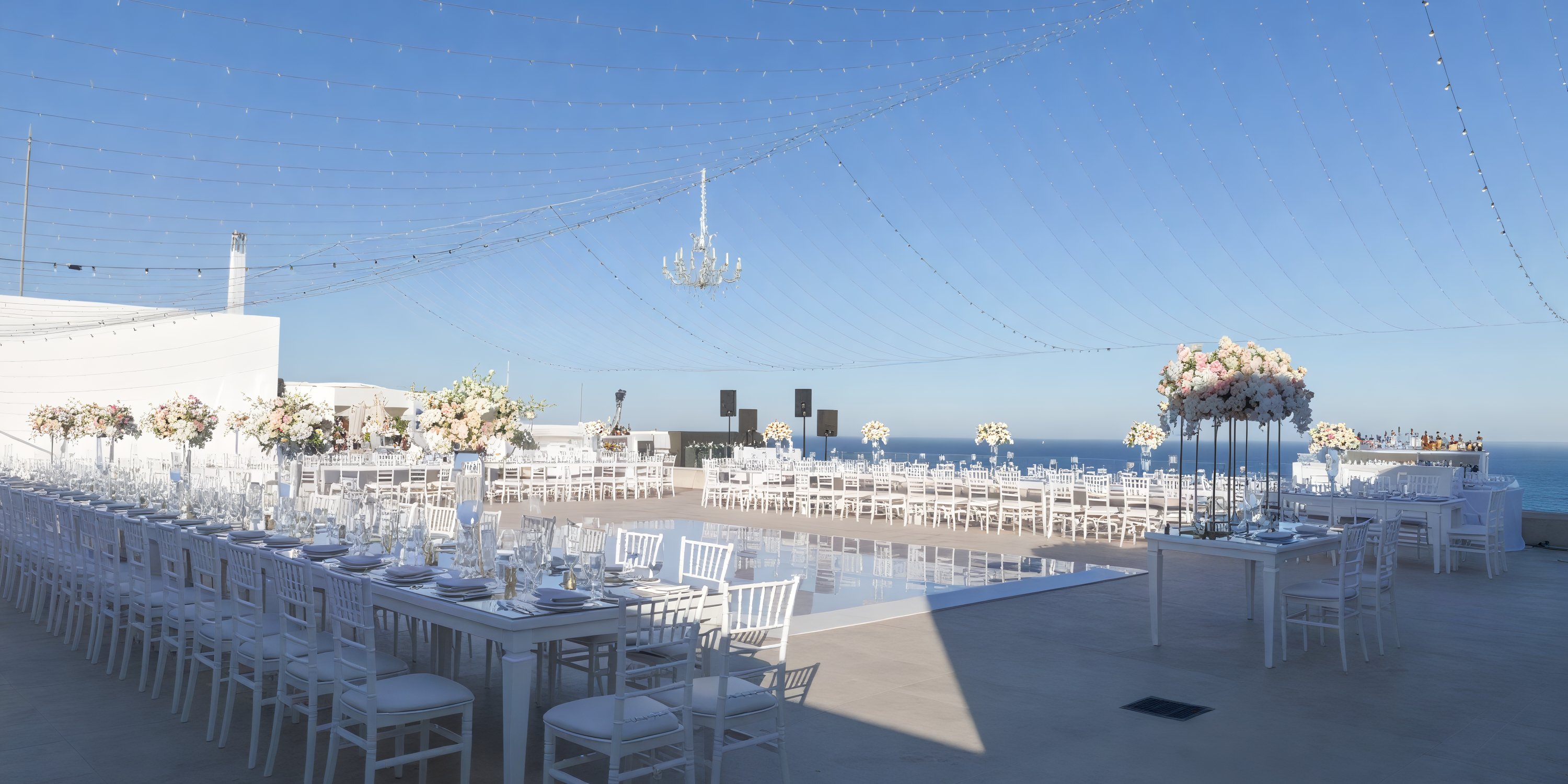 Experience a graceful destination wedding at Garza Blanca Los Cabos, complete with beautifully arranged tables, stunning floral displays, and the perfect backdrop of crystal-clear skies.